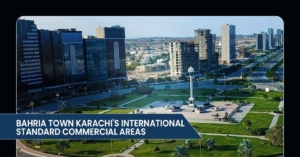 Aerial view of Bahria Town Karachi, showcasing modern commercial buildings and landscaped green spaces with a central monument.